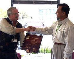 Ken Hands Jules a Plaque